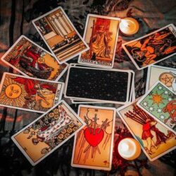 tarot-reading-with-tarot-card-background-and-candlelight-on-the-table-for-astrology-occult-magic-spiritual-horoscopes-and-palm-reading-fortune-teller-tarot-reader-free-photo